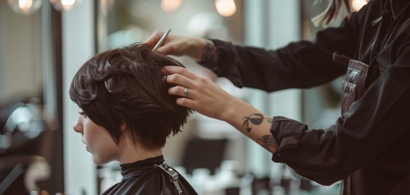 A stylist giving a client a pixie cut. stock image, hd quality, natural look, depth of field, bright, clean, high tech, not busy, simple composition, soft-focused, bright exposure, realistic textures --ar 16:9 --style raw Job ID: 85b3a070-8f3b-43e9-98cb-02fd548a2667