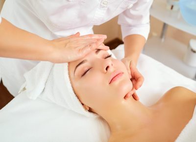 Beautiful woman at a facial massage at a spa salon.