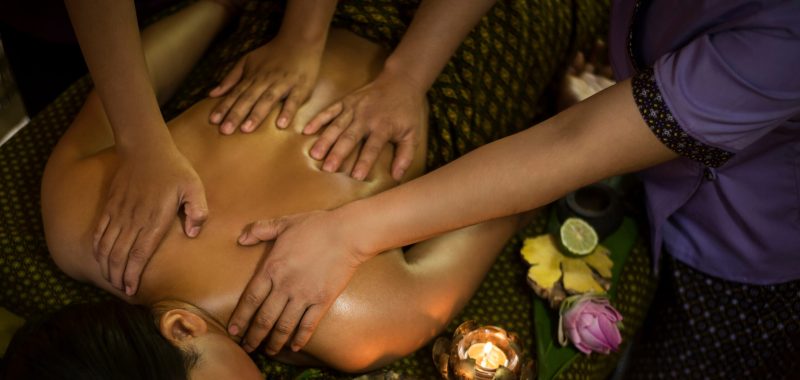 traditional asian thai four hand massage  in tropical spa detail