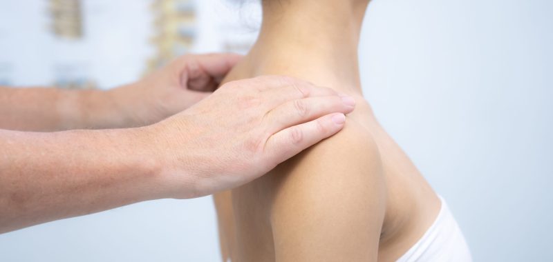 Doctor hand Physicist physical therapy treatment patient in the clinic. Orthopedic medical exam in doctor's hospital office Partnership, traumatology and medical consultation for neck injury